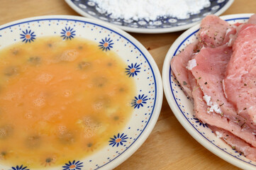 Ingredients on plates for preparing a traditional Polish pork chop