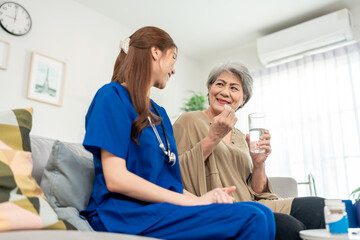 Asian caregiver give consultant to senior woman patient at nursing home. 