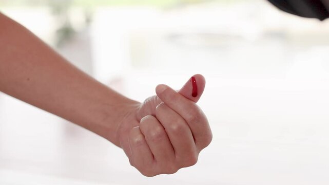 Hand Gesture with Bleeding Thumb Injury