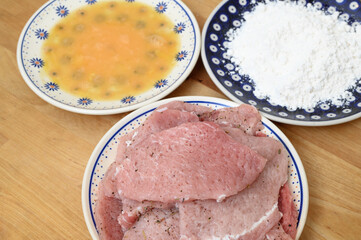 Pork chops, ingredients on plates, top view