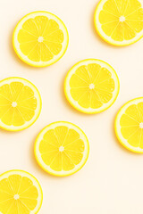 Seamless pattern of fresh lemon slices on pastel background – top view