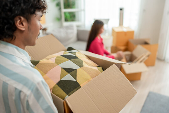 Asian transgender woman and male partner moving to new house together.  - Powered by Adobe