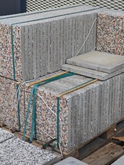 Stacked concrete slabs ready for construction at a building site during daylight hours