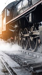 Naklejka premium Vintage steam train, smoke billowing, close-up wheels