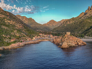 Aerial view town ruins Genoese tower of Porto Corsica France medieval watchtower Mediterranean Sea...