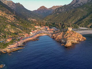 Aerial view town ruins Genoese tower of Porto Corsica France medieval watchtower Mediterranean Sea...