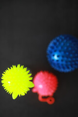 Colorful Spiky Balls on Black Background - Close-Up of Bright Yellow, Red, Blue Toy Balls for Kids