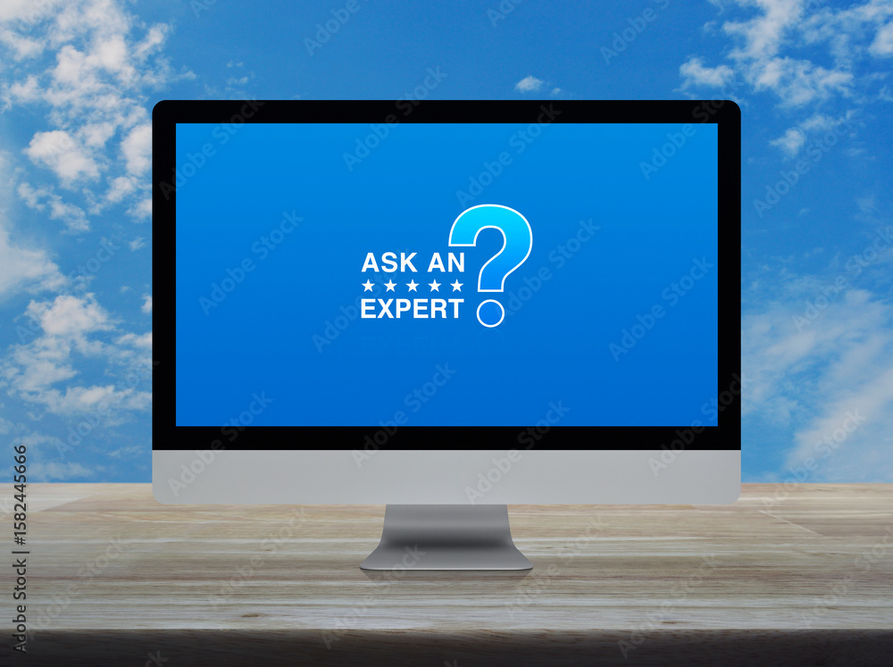 Aufkleber ask an expert with star and question mark sign icon on computer monitor screen on wooden table over 
