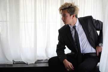 Young Asian businessman in white shirt and tie