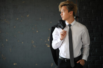 Young Asian businessman in white shirt and tie
