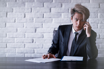 Young Asian businessman in white shirt and tie