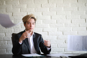 Young Asian businessman in white shirt and tie