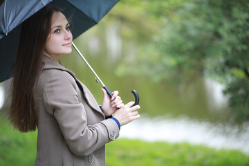 Young girl in a coat in a spring park
