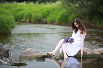 Fototapeta premium Pregnant woman in nature for a walk in the summer