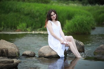 Pregnant woman in nature for a walk in the summer
