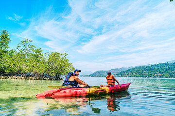 People kayaking on the Ko Man Nai beach in Thailand