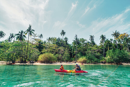 Children kayaking on the Ko Man Nai beach in Thailand - Powered by Adobe