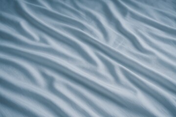 Obraz premium Crease details on a white bedspread with a blue-tinted overlay and vignette effect