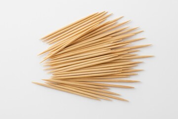 Bamboo toothpicks displayed on a plain white surface
