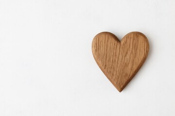 Bright background with a wooden heart and ample space for text