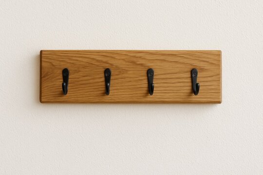 Wooden key hanger and clothing organizer mounted on wall with towel rack