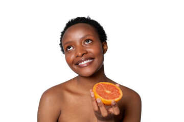 Woman enjoys a fresh orange slice while smiling, showcasing a healthy lifestyle with vibrant colors...
