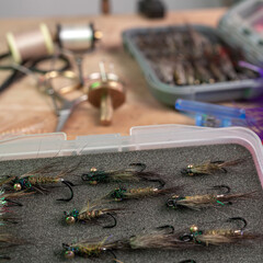Tying a fly fishing fly. A set of various accessories and materials for tying fly fishing lures. Close-up