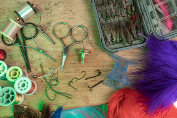 Tying a fly fishing fly. A set of various accessories and materials for tying fly fishing lures. Close-up
