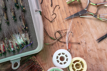 Tying a fly fishing fly. A set of various accessories and materials for tying fly fishing lures. Close-up