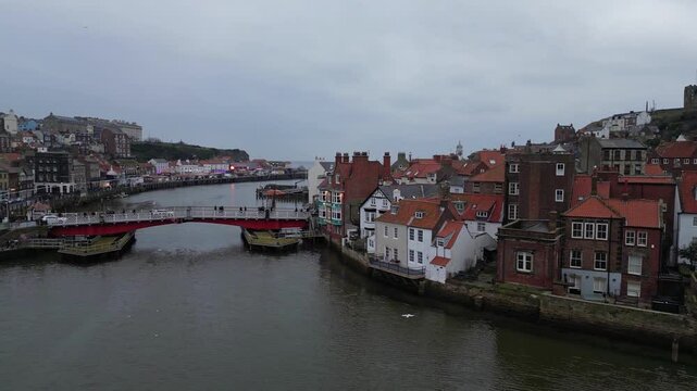 Aerial video captured with DJI Mini 3 Pro, lifting off near Endeavour Wharf, crossing the River Esk, and rising over Whitby town towards the iconic Abbey.