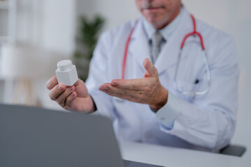 Doctor in a white coat with a stethoscope engaging in a virtual consultation, holding a bottle of...