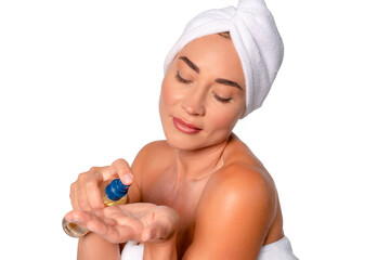 Woman applying body oil after shower in a bathroom with minimalist decor, showcasing self-care...