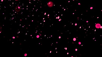 Floating pink dust particles in dark background