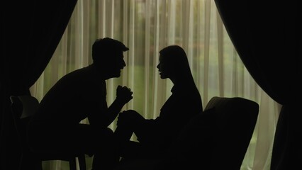 Silhouette of a couple communicating in a domestic setting