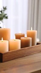 Wooden tray with several lit candles