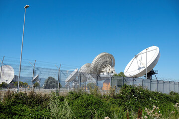 Panoramic view of large satellite dishes at the Fucino Space Centre, set against a backdrop of...