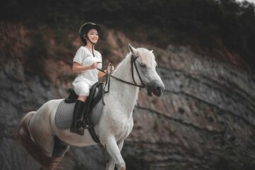 Joyful Rider on a Beautiful White Horse in Natural Landscape