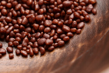 Coffee spice with aromatic cocoa sprinkles in wooden bowl 