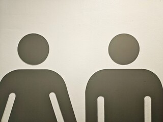 Close up Male and Female Figures on  White Wall for Restroom Sign.