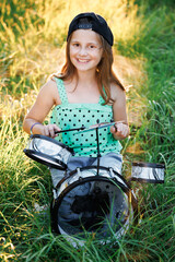 Portrait Young Female Playing Drums During a Band Rehearsal with Warm Sunlight at Daytime. Drummer Girl Practising Before a Live Concert on Stage. Musician From Popular Group