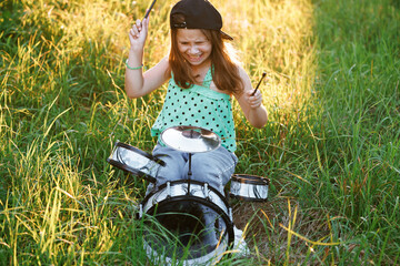 Portrait Young Female Playing Drums During a Band Rehearsal with Warm Sunlight at Daytime. Drummer Girl Practising Before a Live Concert on Stage. Musician From Popular Group