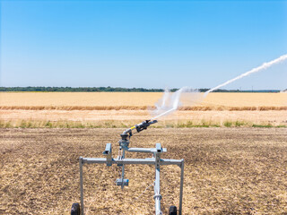 Close up Industrial sprinkler for irrigation of farm fields. Watering during a dry summer