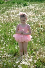 Enchanting Little Ballerina in Dandelions Field. A Whimsical Portrait of Innocence and Dreams.