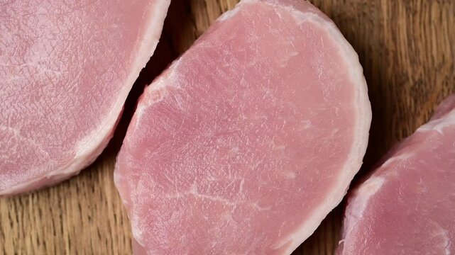 Fresh pork escalopes: juicy boneless cuts on wooden board