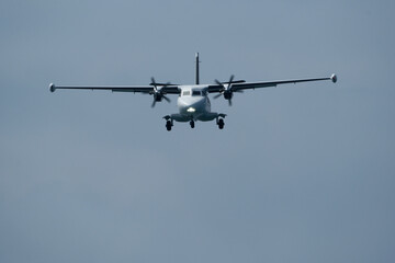 Plane ready to land against clouds, closeup of photo. Airplane in the cloudy sky.