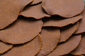 Fermented soybean discs, known as “Thua Nao,” a traditional Thai seasoning used to enhance...
