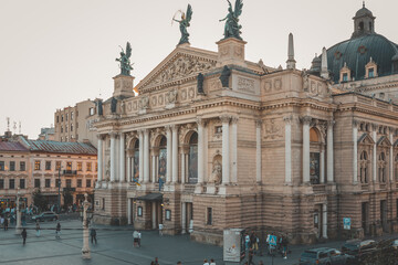 View through a window with curtains framing the iconic Lviv Opera House and square, capturing...
