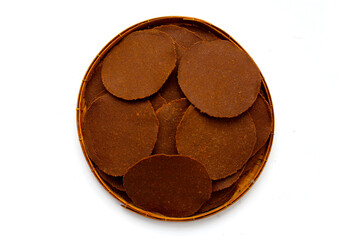 Fermented soybean discs, known as “Thua Nao,” a traditional Thai seasoning used to enhance...