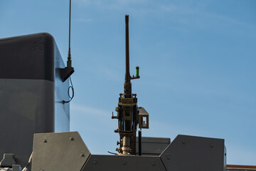 A large-caliber combat machine gun on a turret with an armored shield, mounted on modern military...