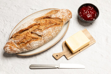Bread with butter and strawberry jam, ingredients for breakfast